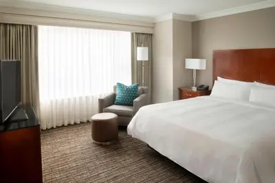 a hotel room with a bed and a chair and a television at Marriott Downtown at CF Toronto Eaton Centre in Toronto