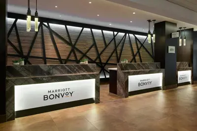 a lobby with two checkout counters in a building at Toronto Airport Marriott Hotel in Toronto