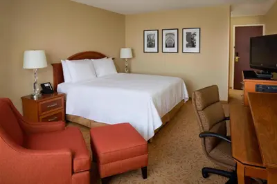 a hotel room with a bed and a chair and a television at Toronto Airport Marriott Hotel in Toronto