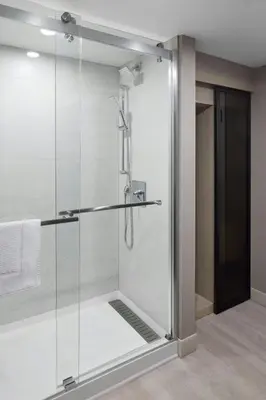 a shower with a glass door in a bathroom at Toronto Airport Marriott Hotel in Toronto