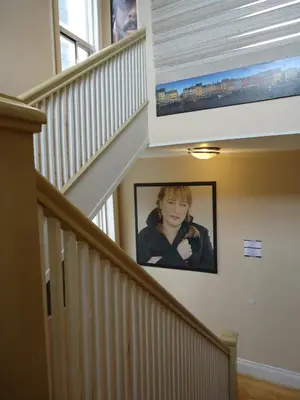 a picture of a girl on the wall in a staircase at The Rex Hotel Jazz & Blues Bar in Toronto