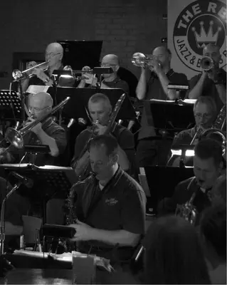 a group of people playing trombones and trumpet at The Rex Hotel Jazz & Blues Bar in Toronto