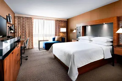 a hotel room with a bed and a television at Sheraton Toronto Airport Hotel & Conference Centre in Toronto