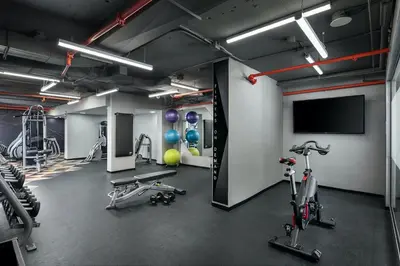 a gym with cardio equipment and a flat screen tv at Sheraton Toronto Airport Hotel & Conference Centre in Toronto
