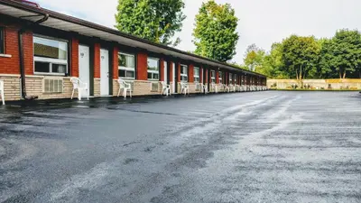 an empty parking lot in front of a building at Kings Inn Midland in Midland
