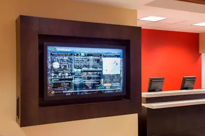 a television on a wall in a room at Courtyard by Marriott Toronto Airport in Toronto