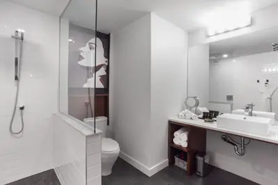 a bathroom with a sink and a toilet and a mirror at Hotel Metro in London