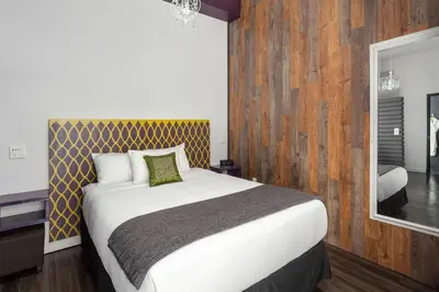 a bedroom with a large bed with a wooden wall at Hotel Metro in London