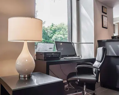 an office with a desk with a lamp and a chair at Comfort Inn in Simcoe