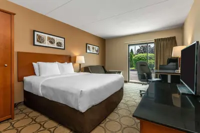 a hotel room with a bed and a television at Comfort Inn in Simcoe
