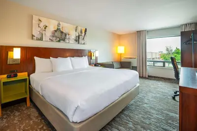a hotel room with a large bed and a large window at Comfort Inn in Newmarket