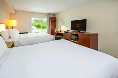 a hotel room with two beds and a flat screen tv at Comfort Inn in Newmarket