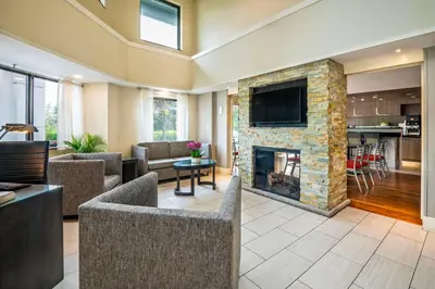 a living room with a fireplace and a tv at Comfort Inn in Newmarket