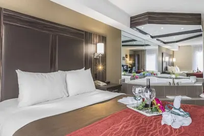 a bedroom with a bed with a tray of wine glasses at Comfort Inn Trenton in Trenton