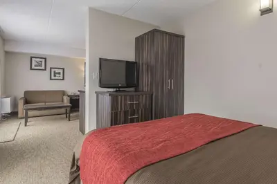 a bedroom with a bed and a flat screen tv at Comfort Inn Trenton in Trenton