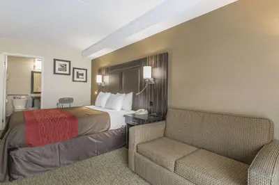 a hotel room with a bed and a chair at Comfort Inn Trenton in Trenton