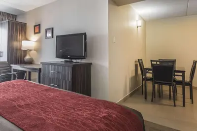 a hotel room with a bed and a flat screen tv at Comfort Inn Trenton in Trenton