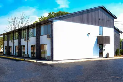 a white building with a black roof at Comfort Inn in Belleville