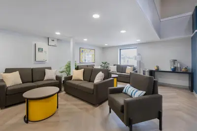 a living room with couches and chairs and a table at Comfort Inn in Belleville