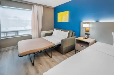 a small room with two beds and a window at Comfort Inn in Belleville