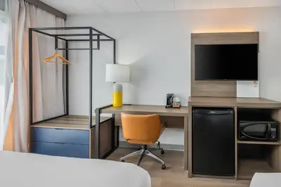 a hotel room with a desk and a tv at Comfort Inn in Belleville