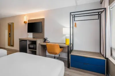 a hotel room with a bed and a desk with a chair at Comfort Inn in Belleville