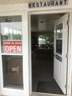 an open sign in the door of a restaurant at Shenstone Motor Inn in Wiarton