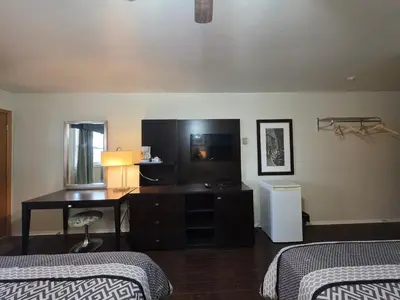 a hotel room with two beds and a desk at Shenstone Motor Inn in Wiarton