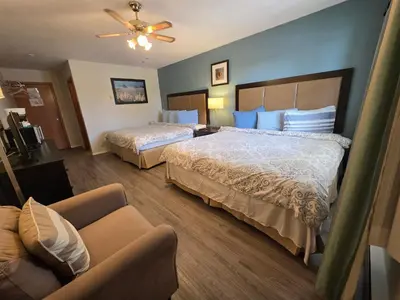a hotel room with two beds and a couch at Shenstone Motor Inn in Wiarton
