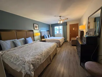 a hotel room with two beds and a television at Shenstone Motor Inn in Wiarton