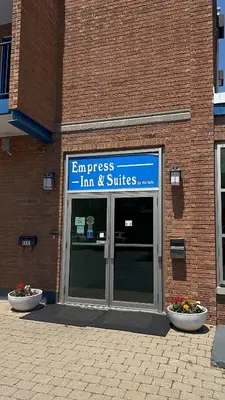 an entrance to a building with a sign on it at Empress Inn and Suites by the Falls in Niagara Falls