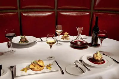a table with plates of food and glasses of wine at Sterling Inn & Spa in Niagara Falls
