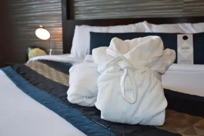 a hotel room with towels on a bed at Sterling Inn & Spa in Niagara Falls
