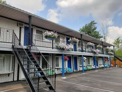 a building with flowers on the balconies and a staircase at Blue Moon Motel in Niagara Falls