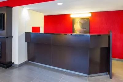 a bar in a room with a red wall at Comfort Inn in Pickering
