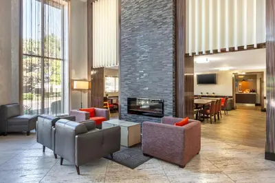 a living room with couches and a fireplace at Comfort Inn in Burlington