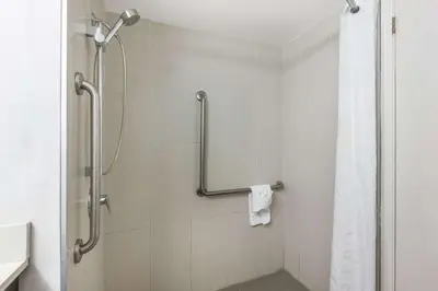 a bathroom with a shower with a shower curtain at Comfort Inn in Burlington
