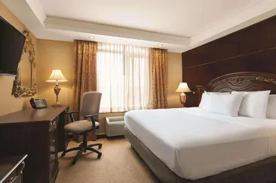 a hotel room with a large bed and a desk at Radisson Hotel Toronto Airport West in Mississauga