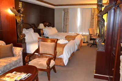 a hotel room with two beds and a couch at Radisson Hotel Toronto Airport West in Mississauga