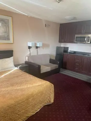 a hotel room with a bed and a couch at Niagara Lodge & Suites in Niagara Falls