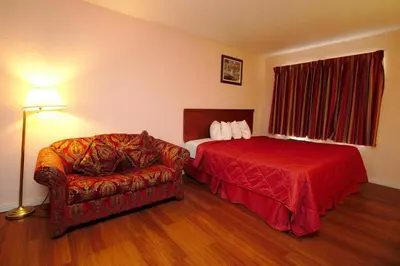 a hotel room with a bed and a couch at Niagara Lodge & Suites in Niagara Falls