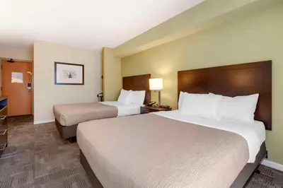 a hotel room with two beds and a television at Quality Inn in Peterborough