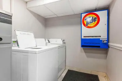 a laundry room with a pepsi sign on the wall at Quality Inn in Peterborough