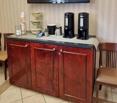 a counter with two coffee makers on top of it at Quality Inn in Peterborough