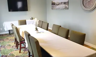 a meeting room with a long table and chairs at Quality Inn in Peterborough