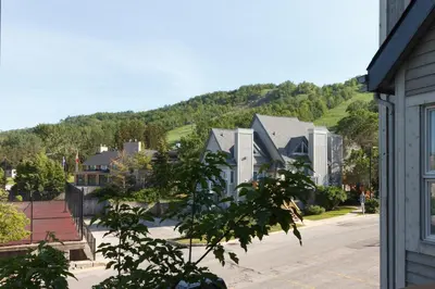 a view of a town with a mountain in the background at Mountain Side Condo Loft at The Blue Mountains in Blue Mountains