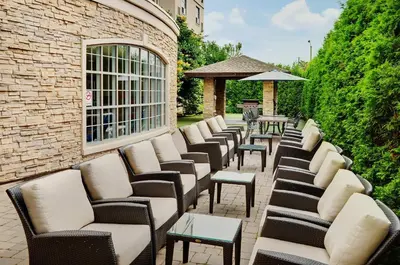 a row of chairs and tables on a patio at Staybridge Suites Oakville Burlington by IHG in Oakville