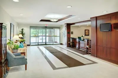 a large living room with a couch and a tv at Staybridge Suites Oakville Burlington by IHG in Oakville