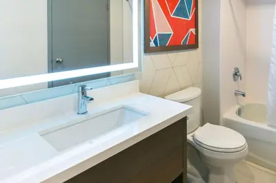 a bathroom with a sink and a toilet at Comfort Suites in London