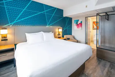 a bedroom with a large white bed and a desk at Comfort Suites in London